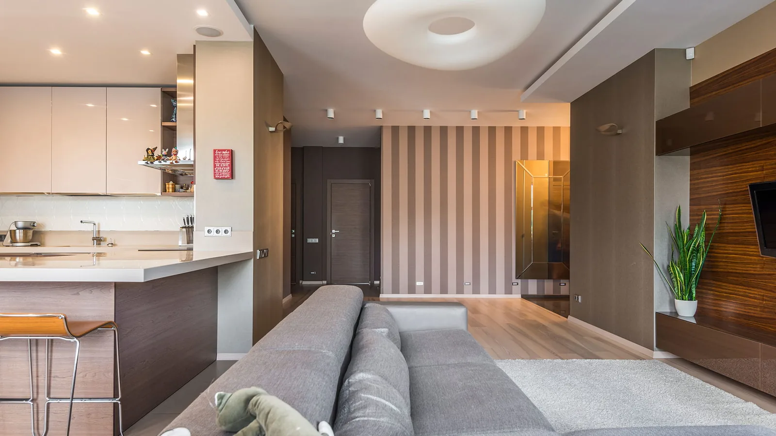 Open-plan living space with a spotless kitchen bar